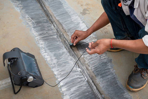 The inspectors are checking defect in welded of steel plate add joint with process Ultrasonic testing (UT) of Non-Destructive Testing(NDT) at industrial factory.